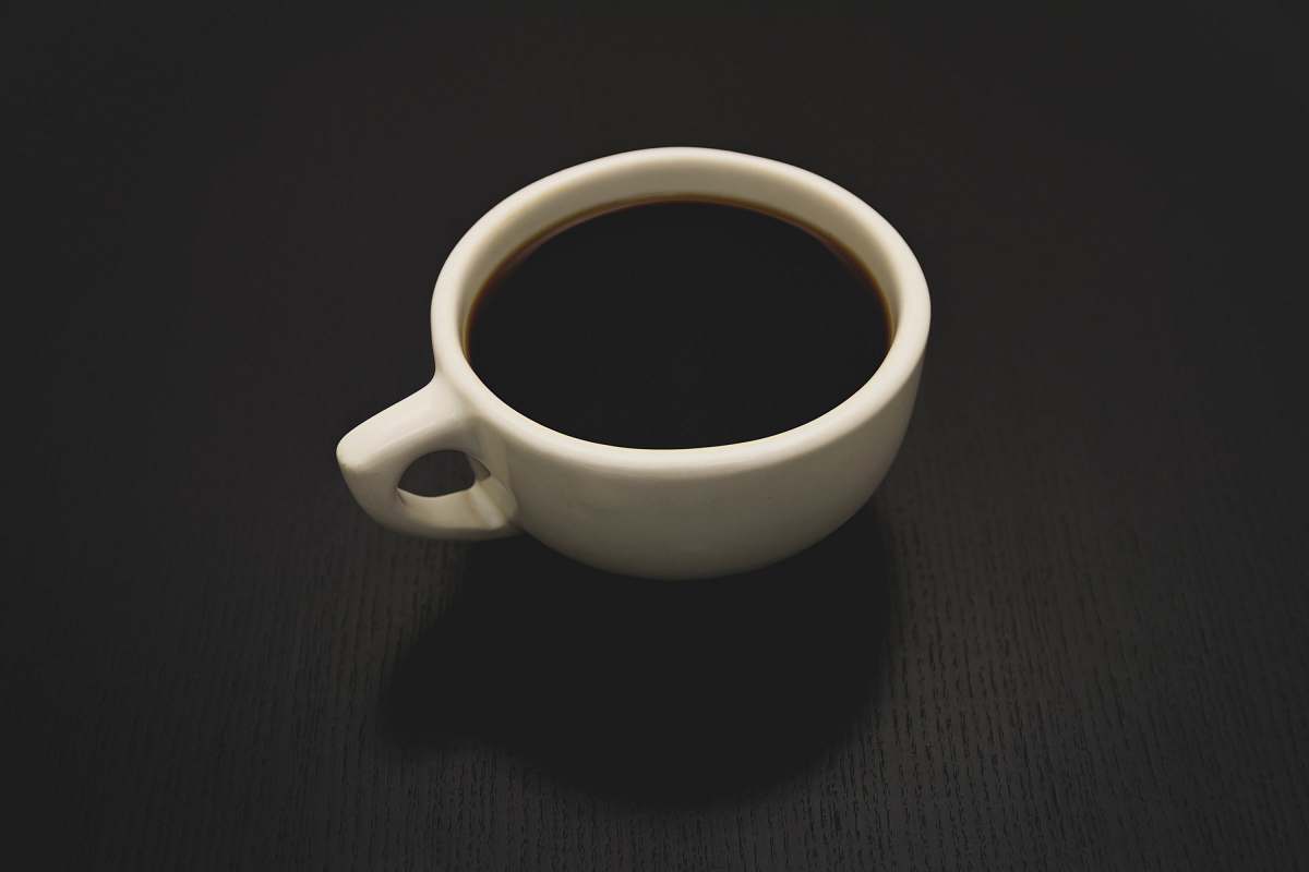 coffee cup photo of white ceramic teacup filled with liquid black